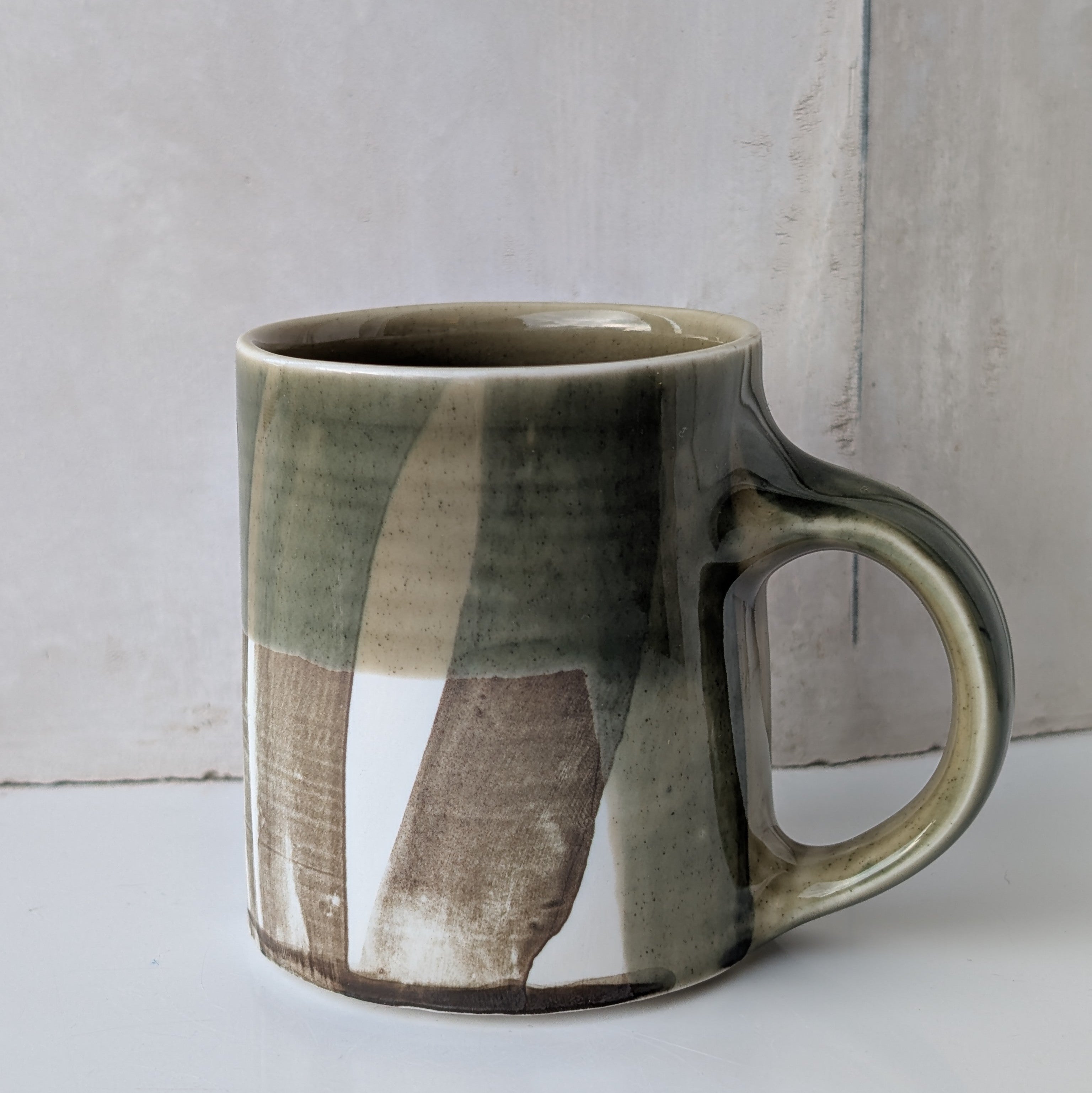 Small mug, brush strokes and exposed porcelain with Sage