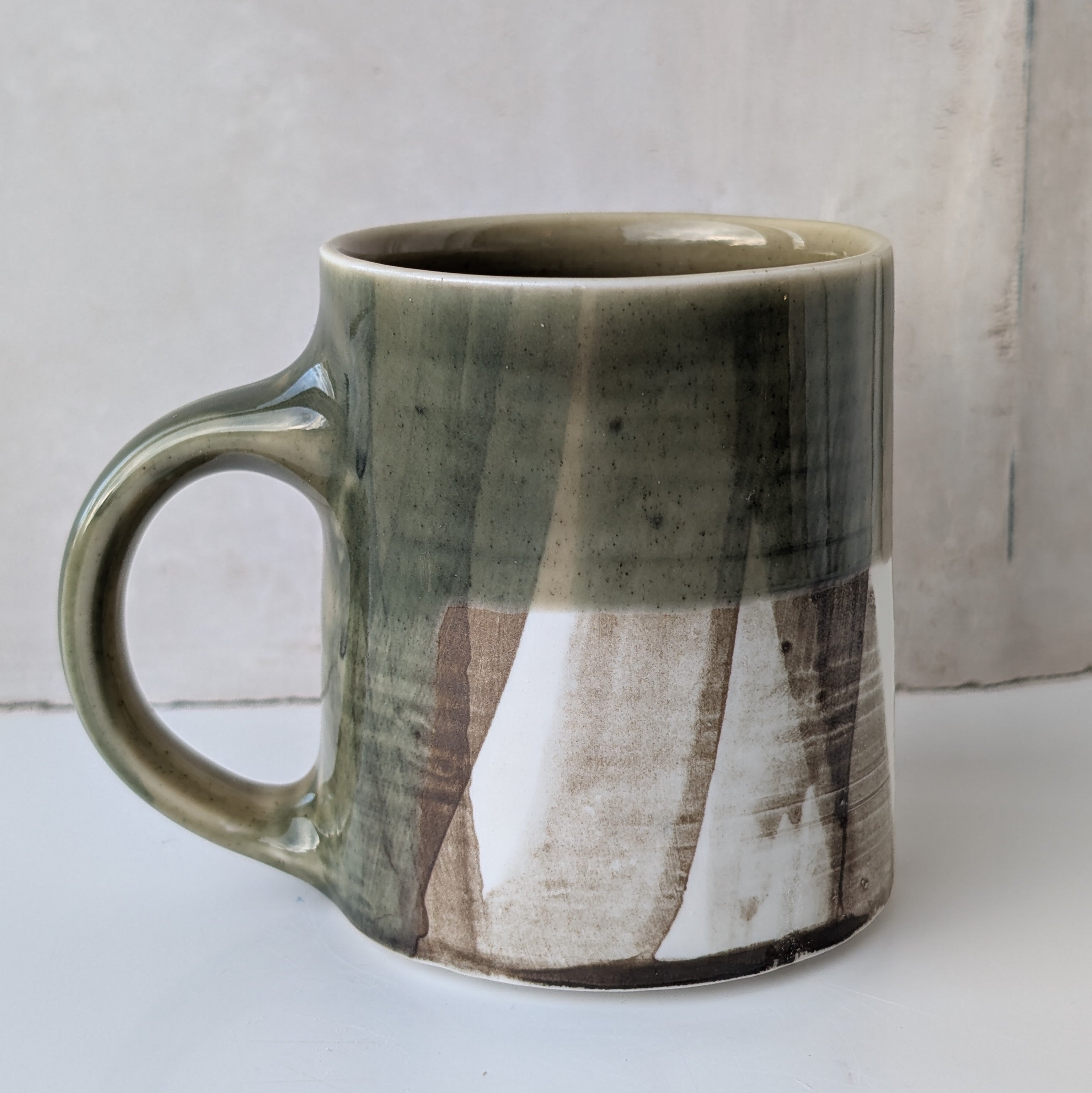 Small mug, brush strokes and exposed porcelain with Sage